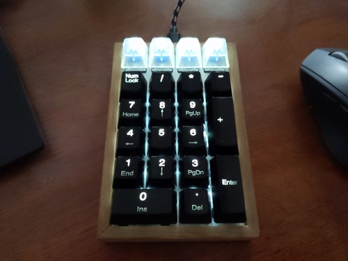 Wooden frame, LEDs on, with keycaps.